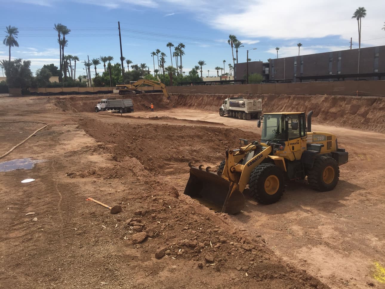 Heavy equipment excavating a large retention basin